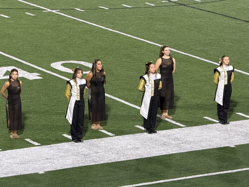 Band and Color Guard members on field