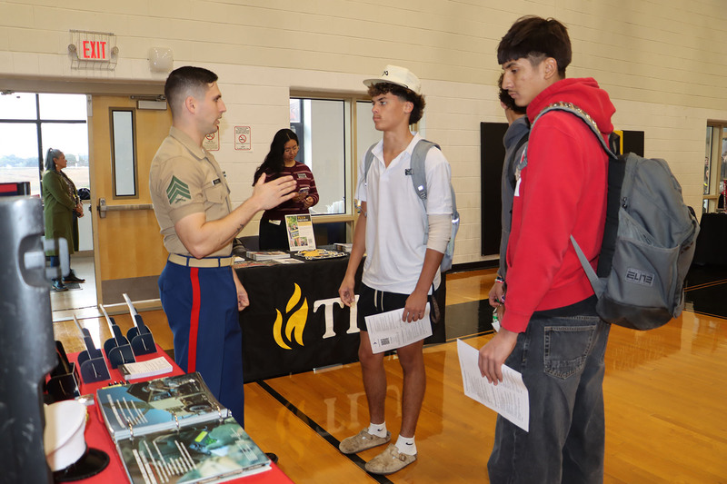 A Marine recruiter talks with students