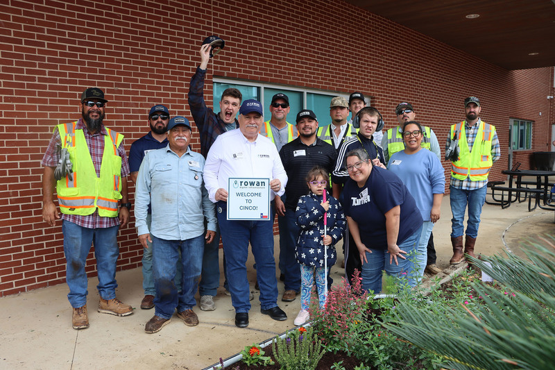 Volunteers with students from the Life Skills class working in the garden