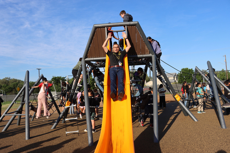 Lytle Mayor Ruben Gonzalez tries out the new slide
