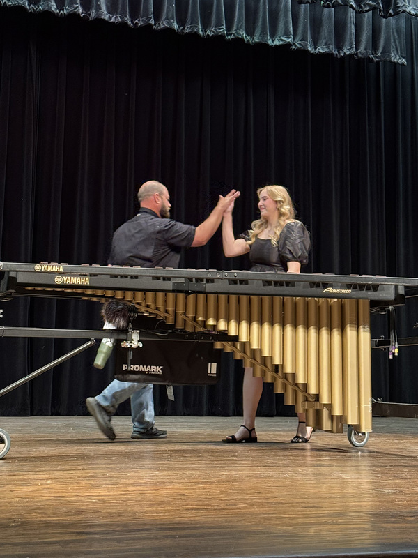 Taryn McDonald gets a high five from Band Director Mr. Chessher