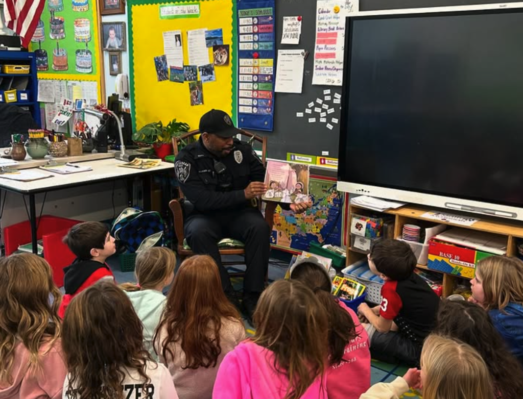 Police officer reading to students