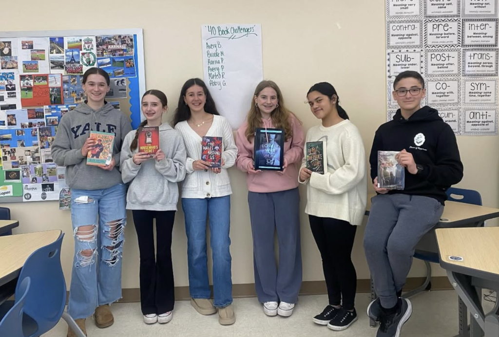 Saxe middle school students holding up their books