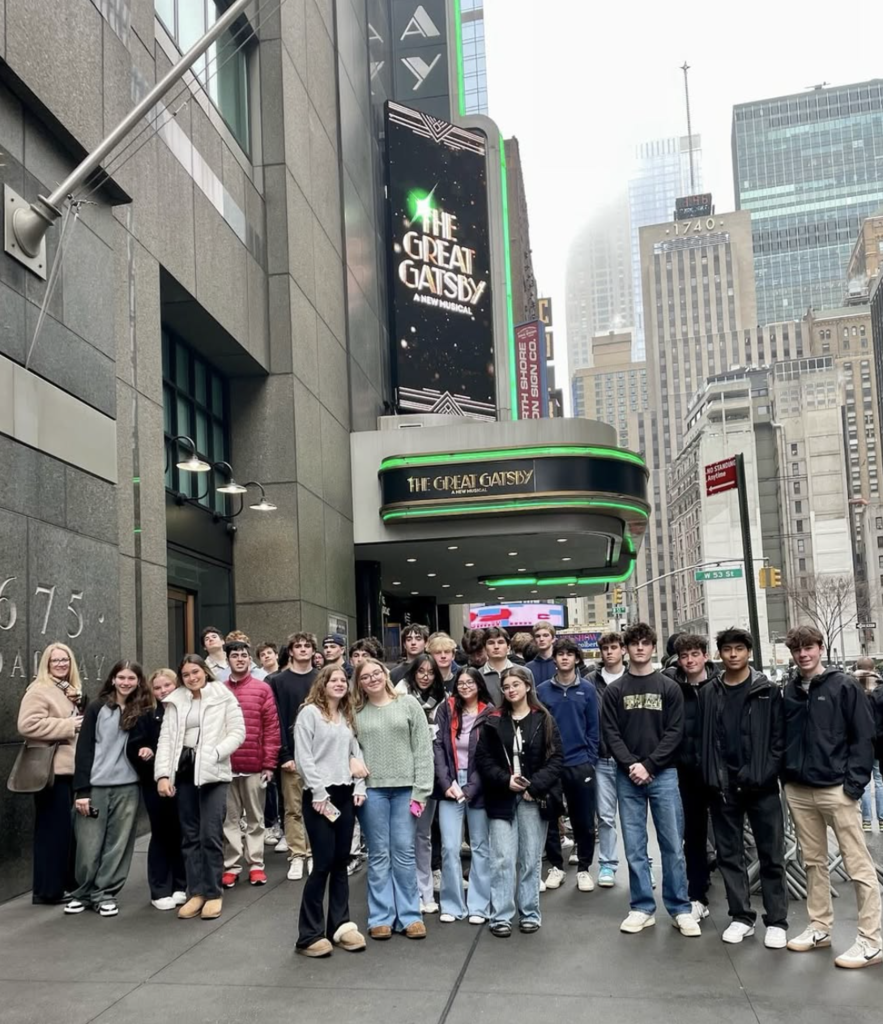 High school students standing in front of a theater showing The Great Gatsby musical