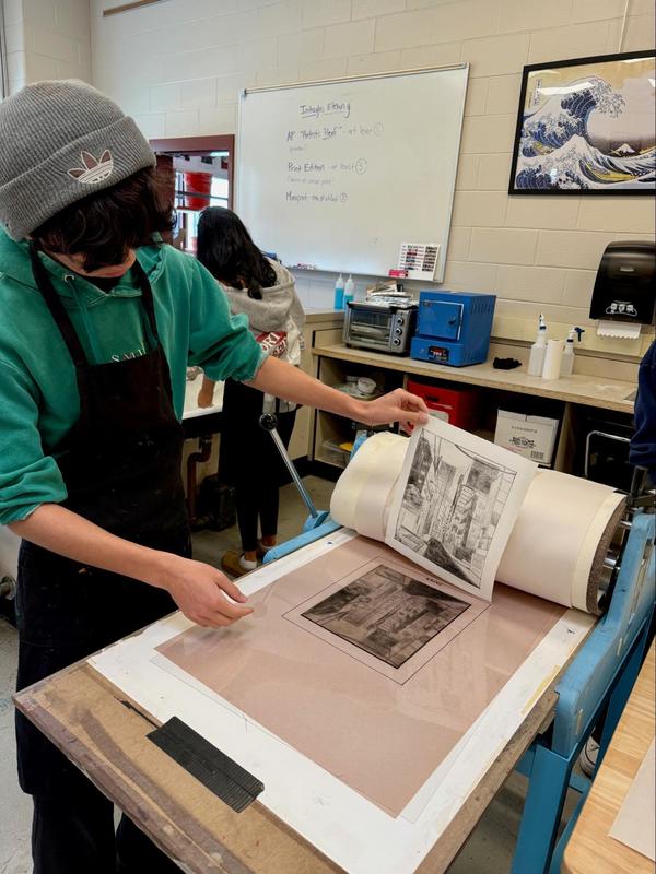 student using printing press to explore curiosity