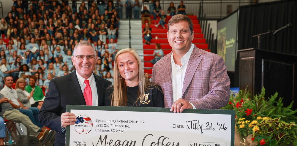 Megan Coffey Our Teacher of the Year, Receives a Check for $4500 in Honor of her Award. 