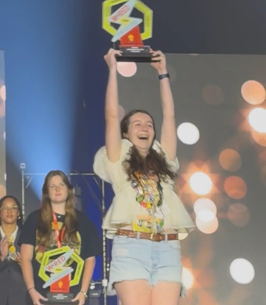 Kylie Fowler Holds Up a Trophy