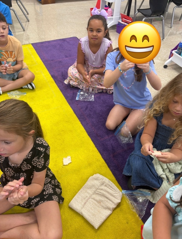 Students play with clay.