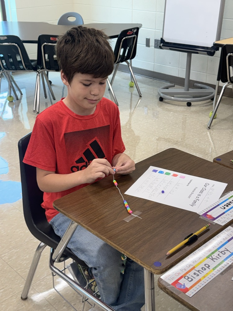 boy making bracelet