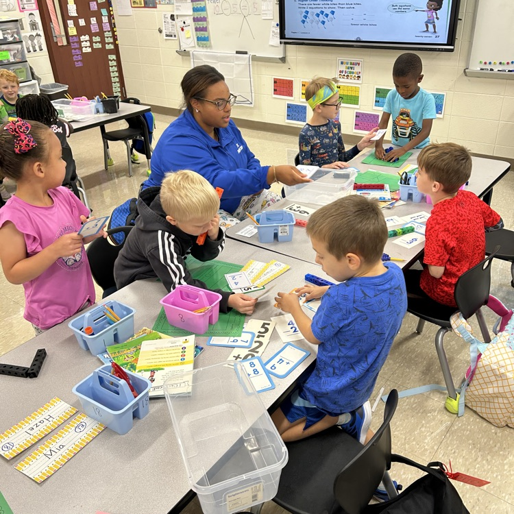 Nitro Nicole and students with math manipulatives.
