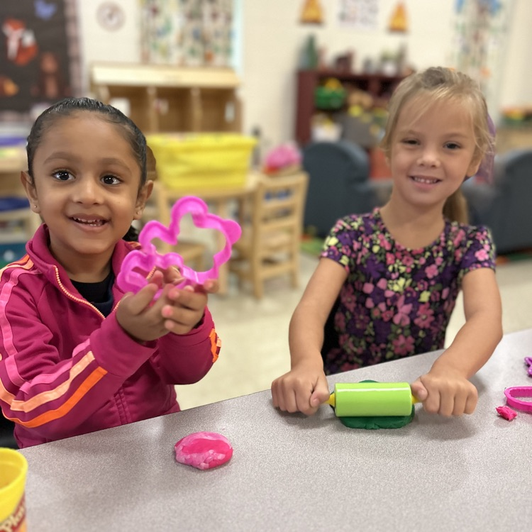 Girls using play dough.