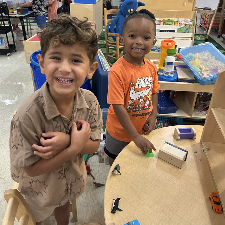 Boys playing with small animals.