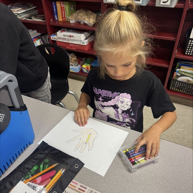 girl drawing a hand