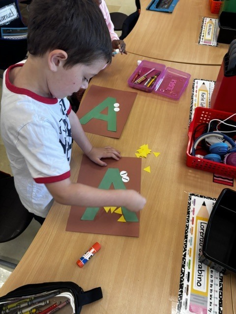 Kindergarten students make A for Alligator! 