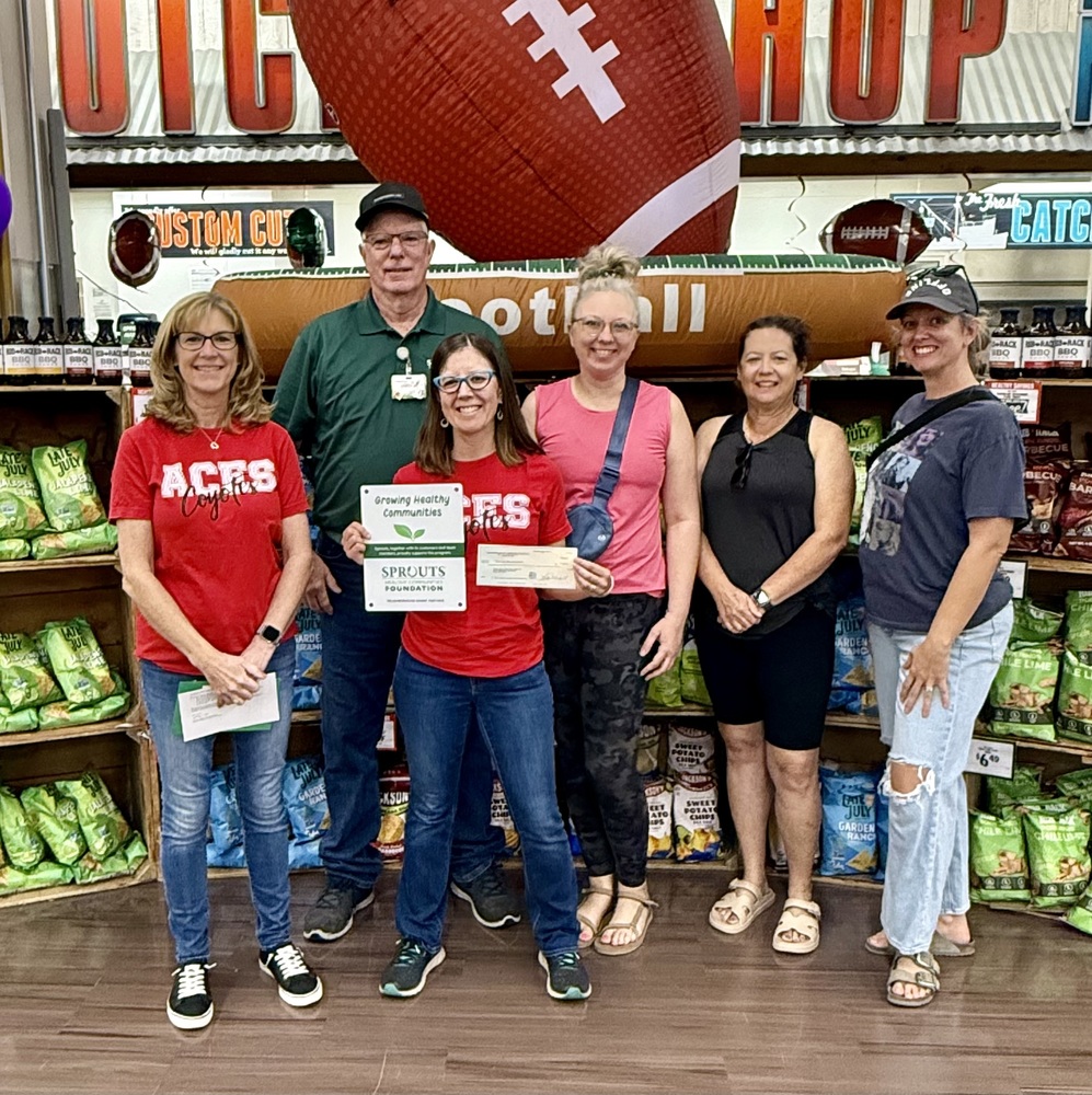 Deb and ACES staff receiving check
