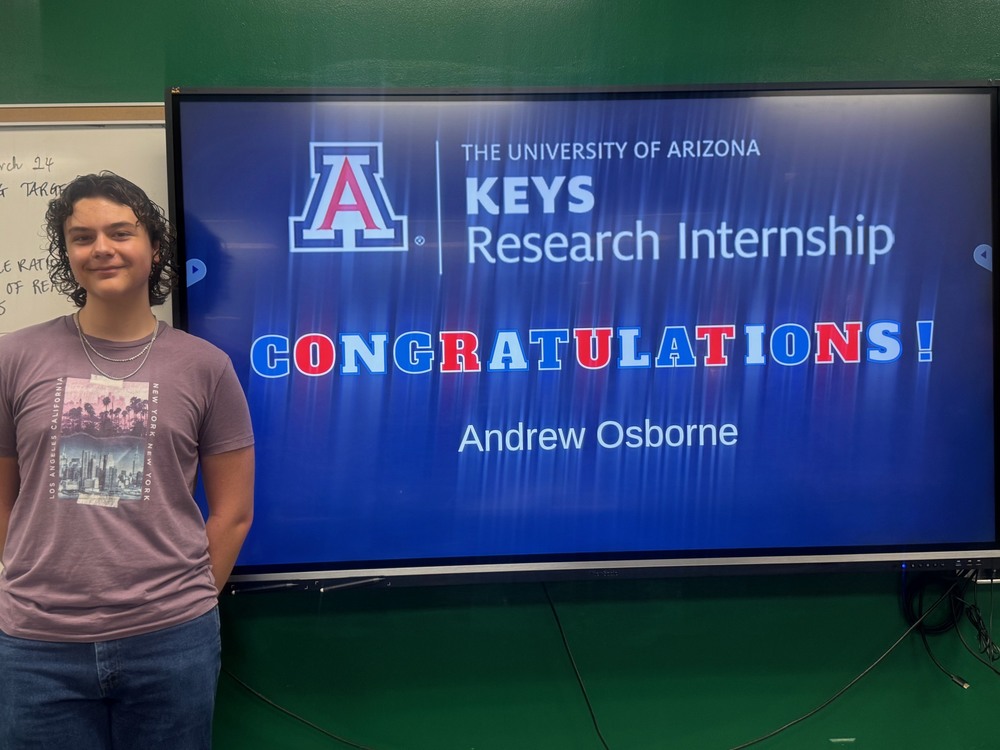 Andrew in front of a screen that says Congratulations Andrew Osborne