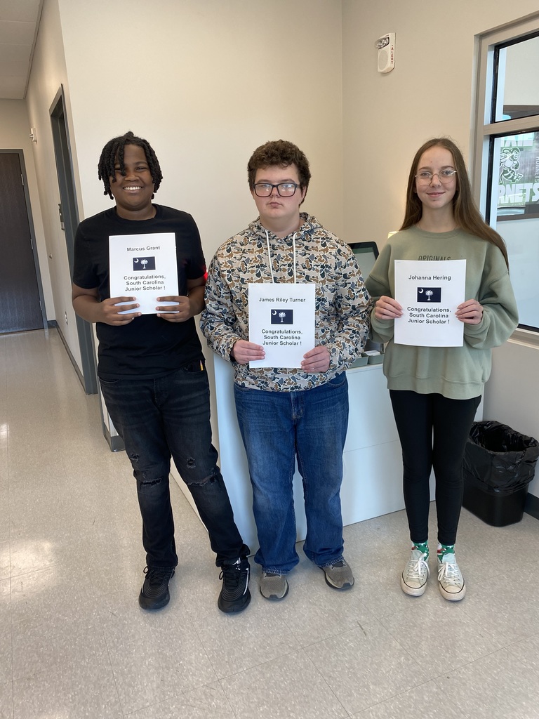 The three Junior Scholars holding their certificates