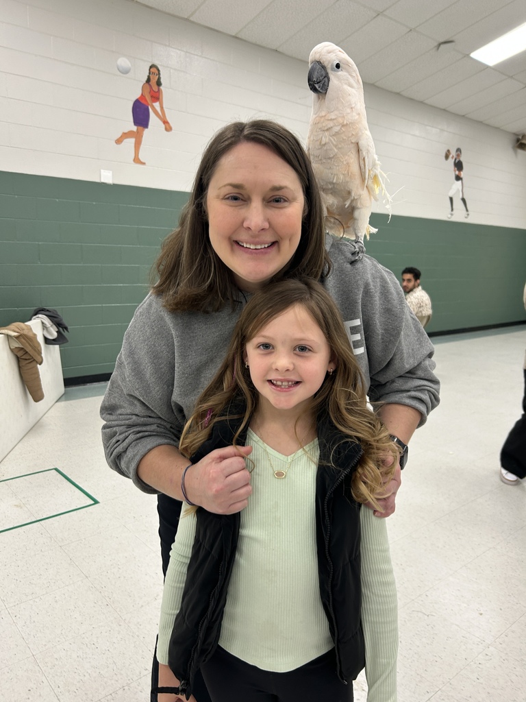 principal and student posing for a photo with a bird