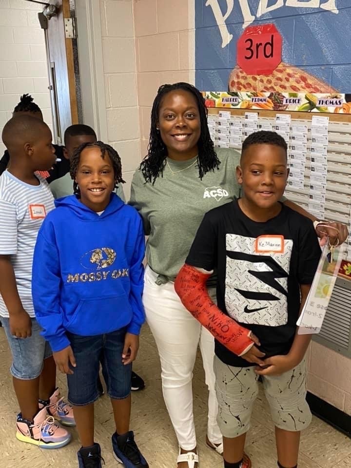 teacher smiling with students