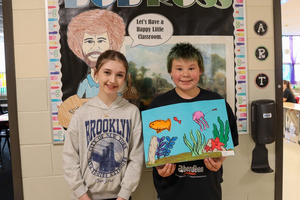 Isabella Carlson and Freya Meyer with Finding Nemo Jr. artwork