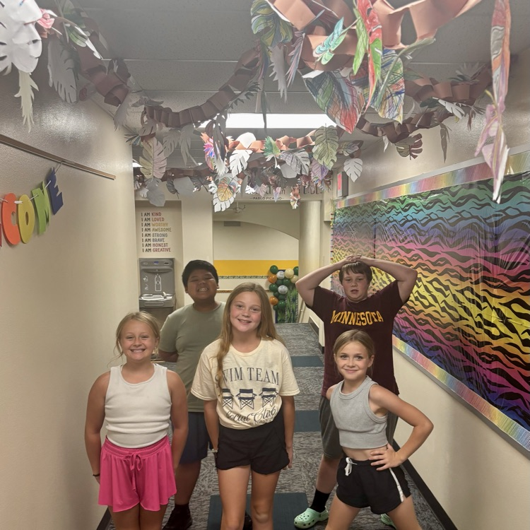 Students pose in front of the art installation