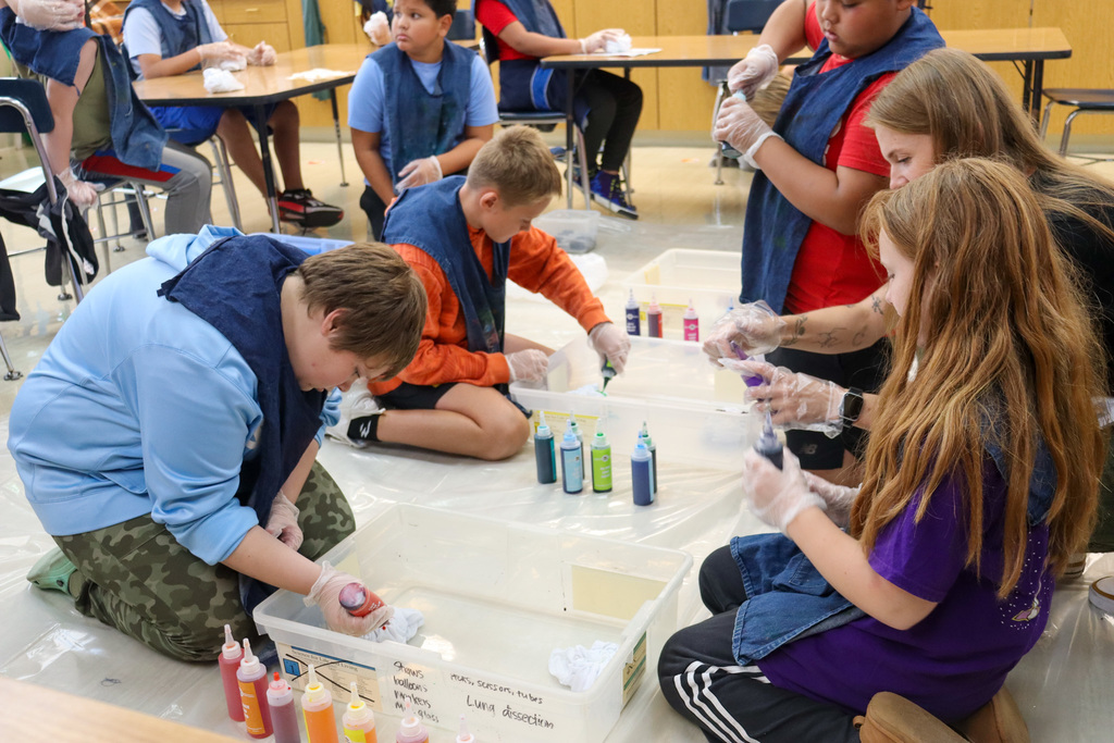 O.M. Tiffany students tie-dyeing T-shirts
