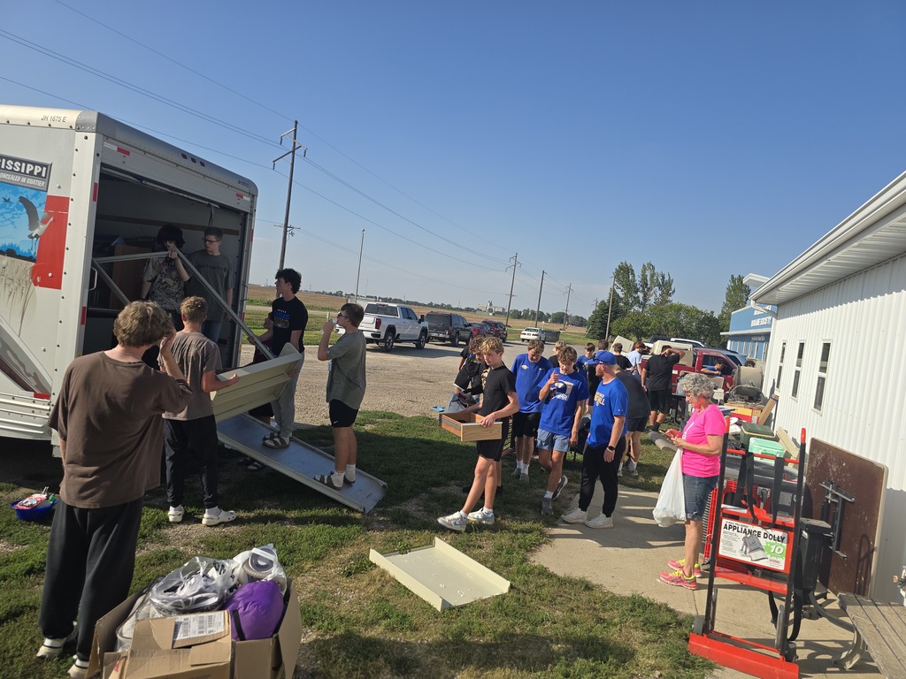 Football players helped load up donated furniture for the AAHS Second Paw Sale.