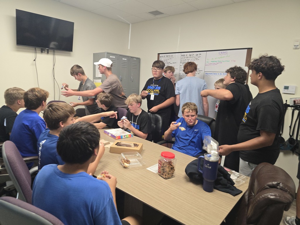 Football players helped load up donated furniture for the AAHS Second Paw Sale.