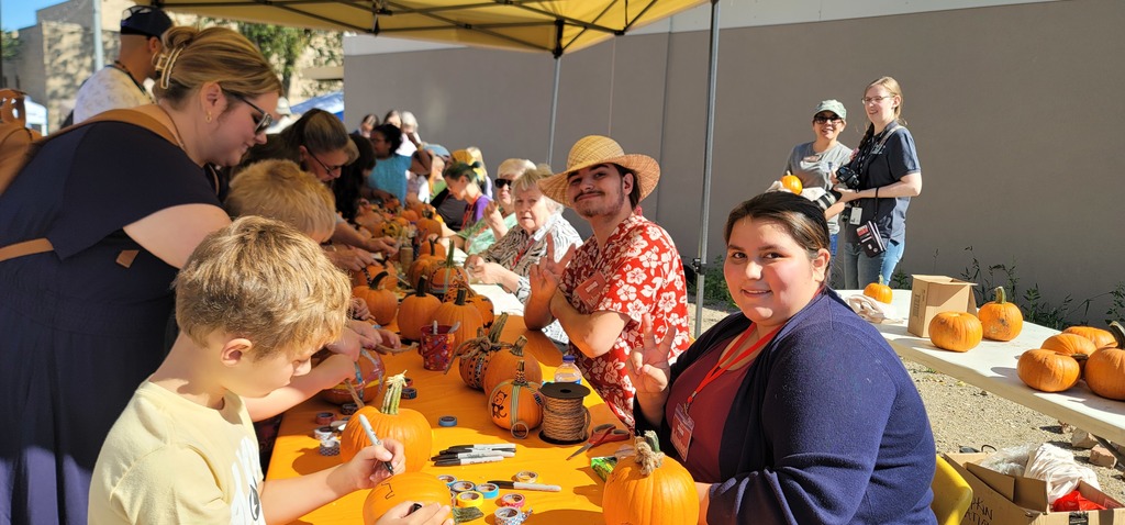 Alta Three Legs and Dante Kholeman helping at the pumpkin decorating station!