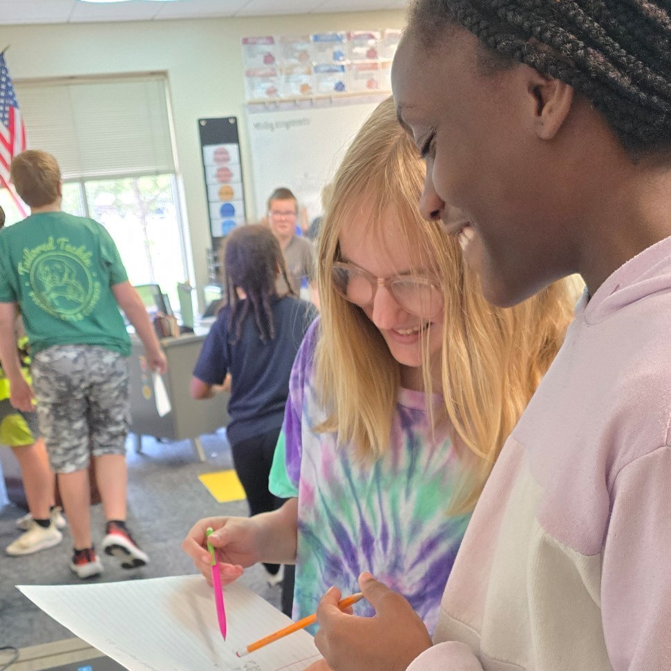 6th grade students work together in language arts to find figurative language.