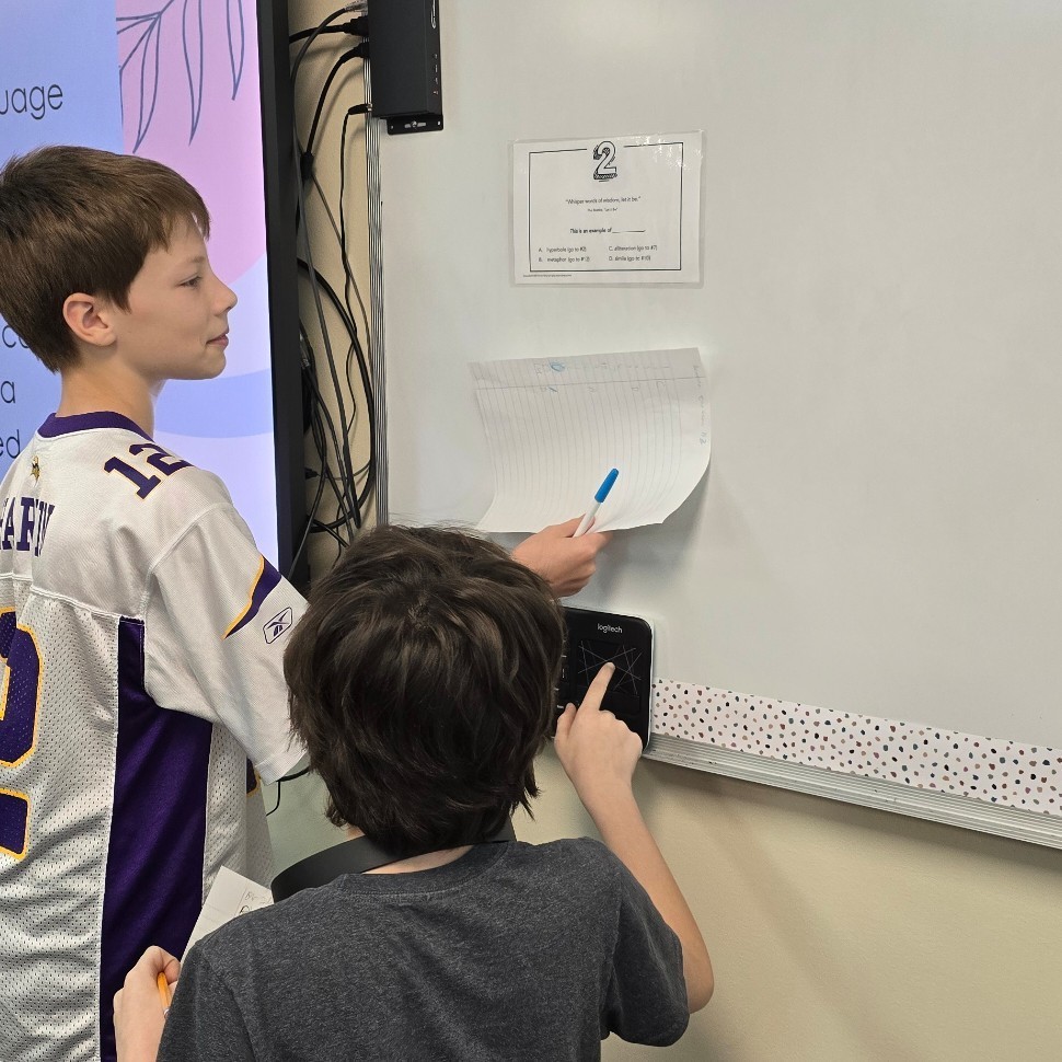 Students work together in language arts to find figurative language.