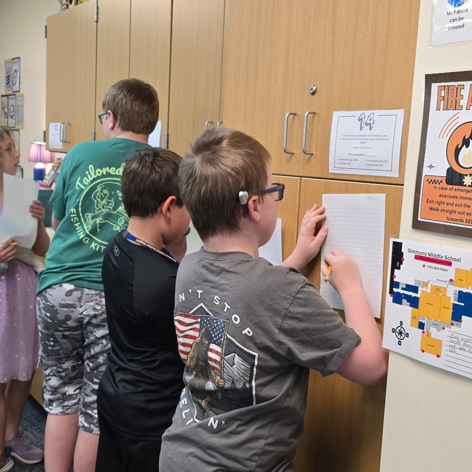 Students work together in language arts to find figurative language.