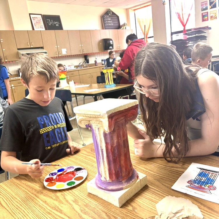 Students paint pillars in art!