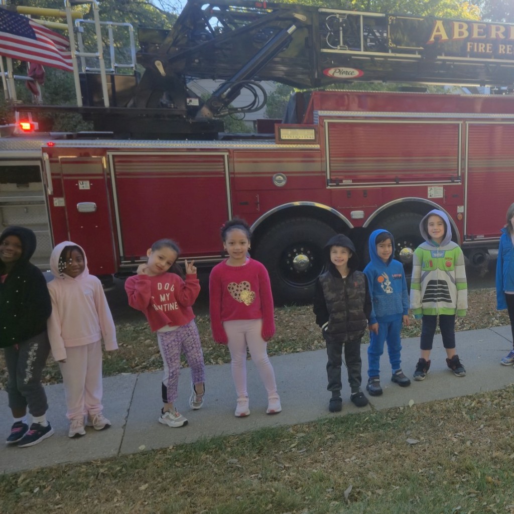 students in front of firefighters truck
