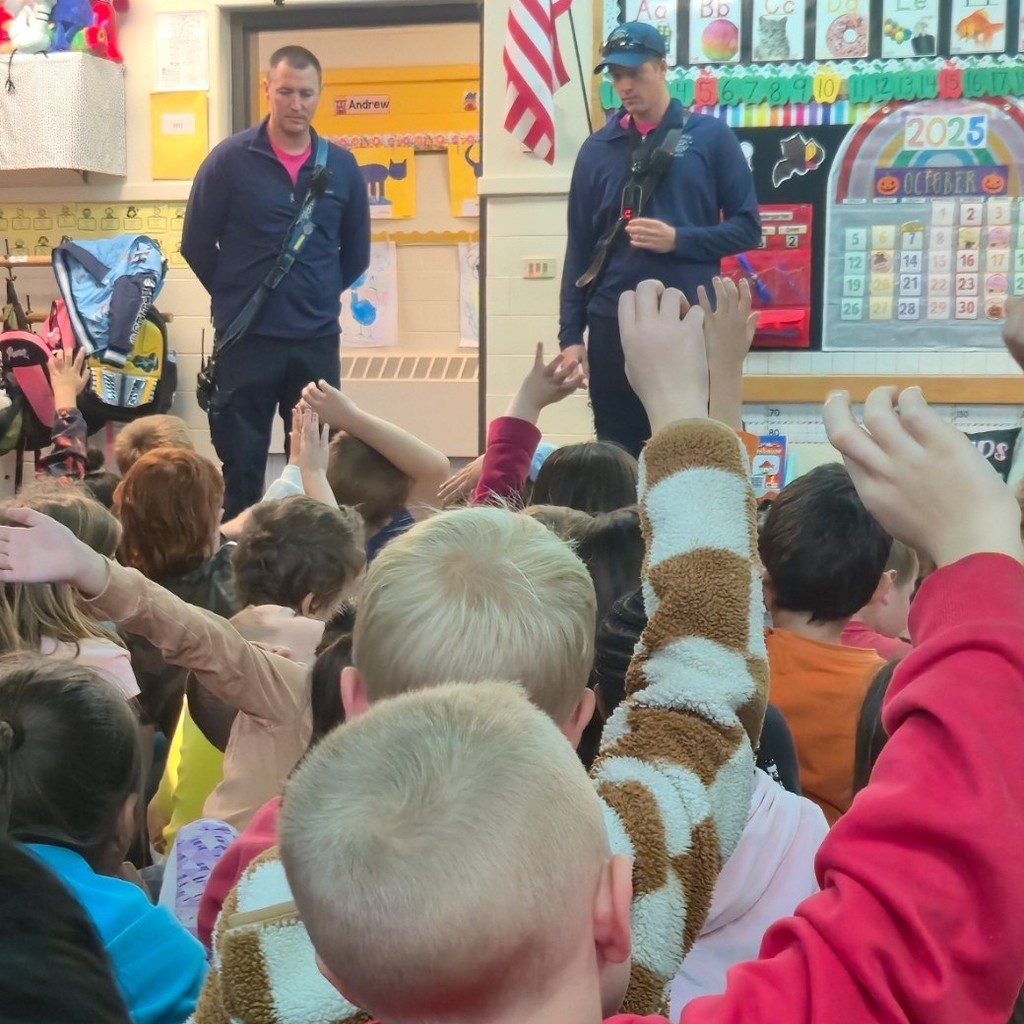 kids raising their hands for the firefighters