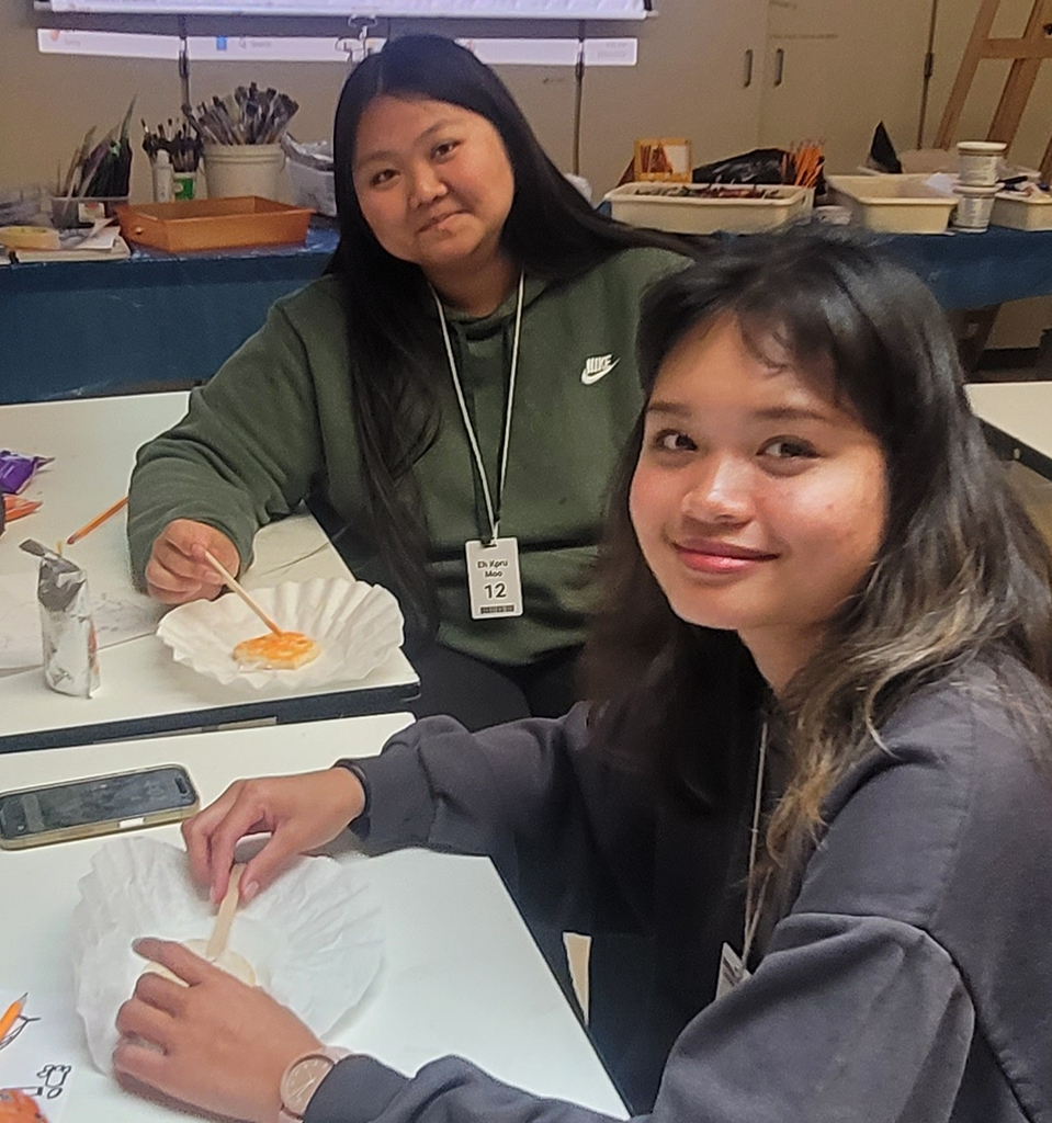 Art club members Eh Tenna and Eh Moo  are having fun at art club decorating cookies!