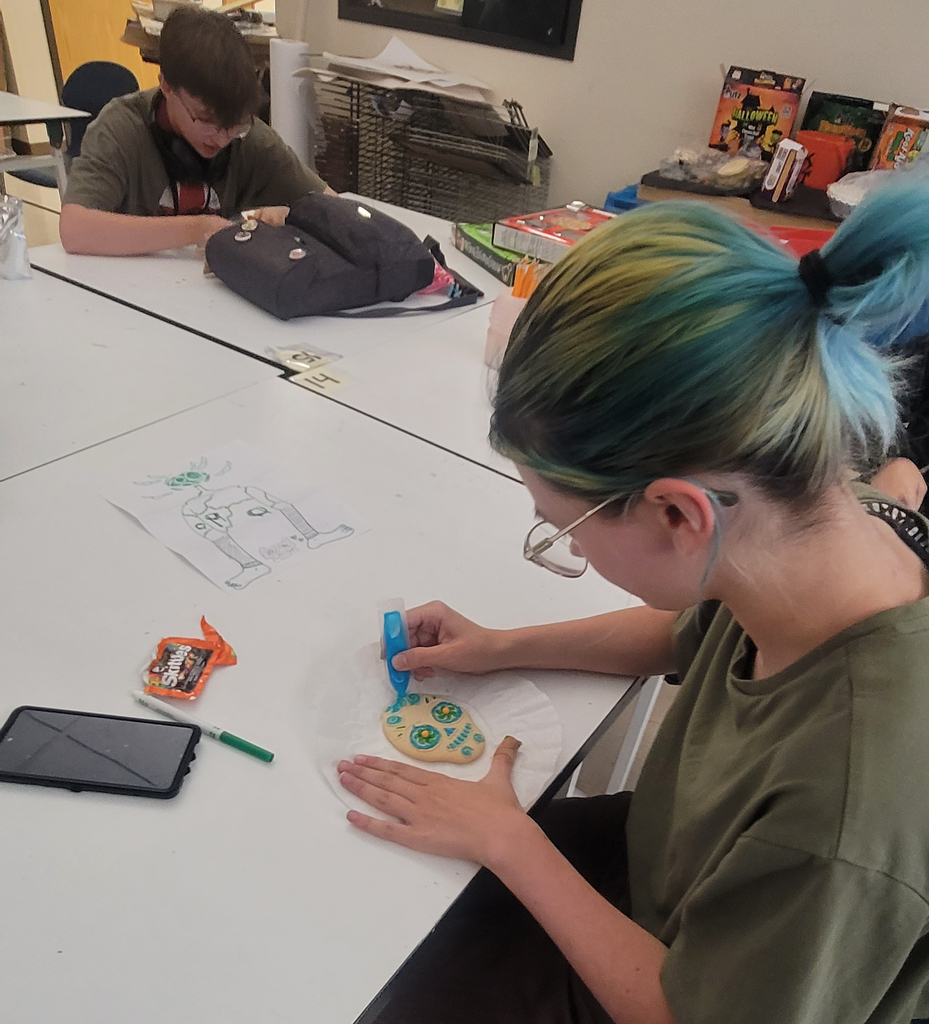 Here Raini B. and Kaelyn B. are decorating their sugar cookie skulls after creating their exquisite corpse drawings!
