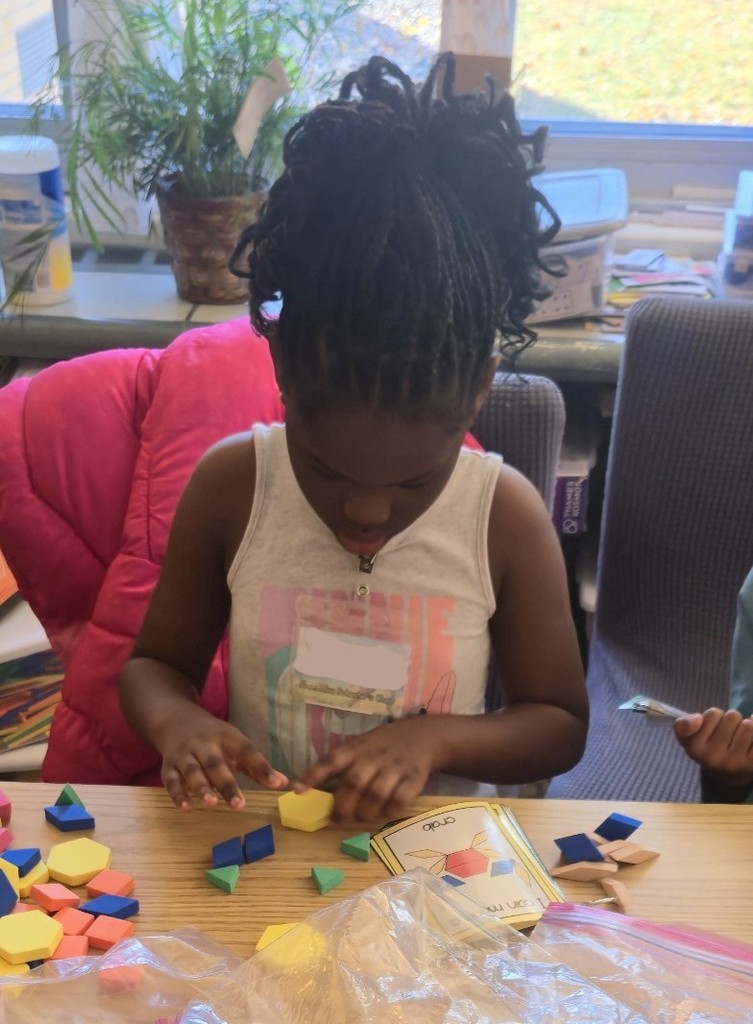 student using pattern blocks