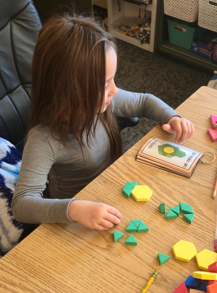 student using pattern blocks