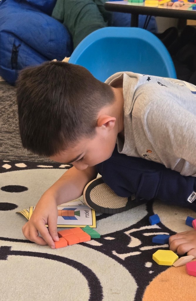 student using pattern blocks