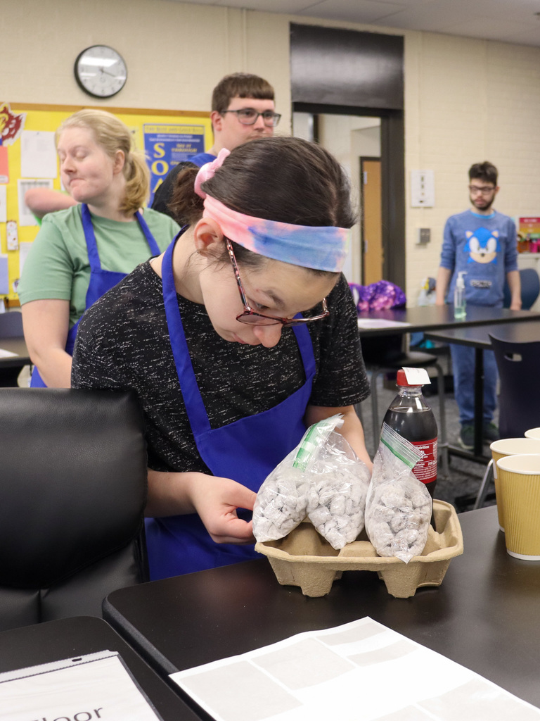 TLC student checking over a coffee shop delivery