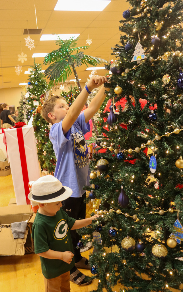 O.M. Tiffany students decorating the Golden Eagle tree at the Feztival of Trees