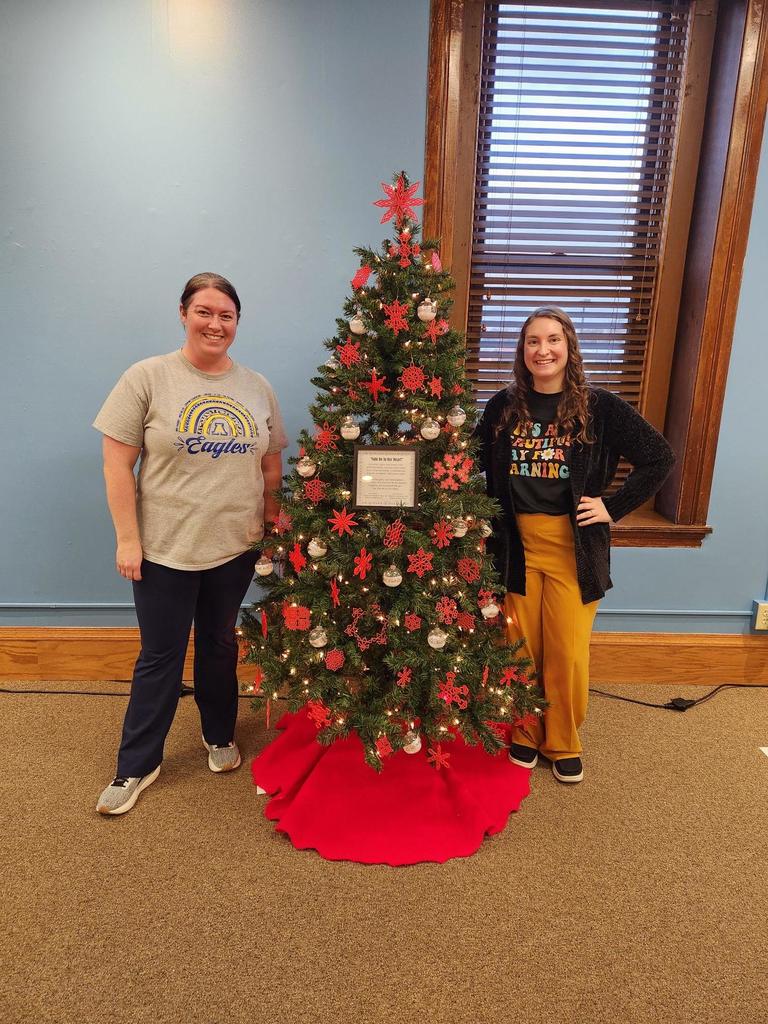 Mrs. Conklin and Mrs. Barbato with the Christmas Tree Lane tree that contains decorations made by SMS and HMS students