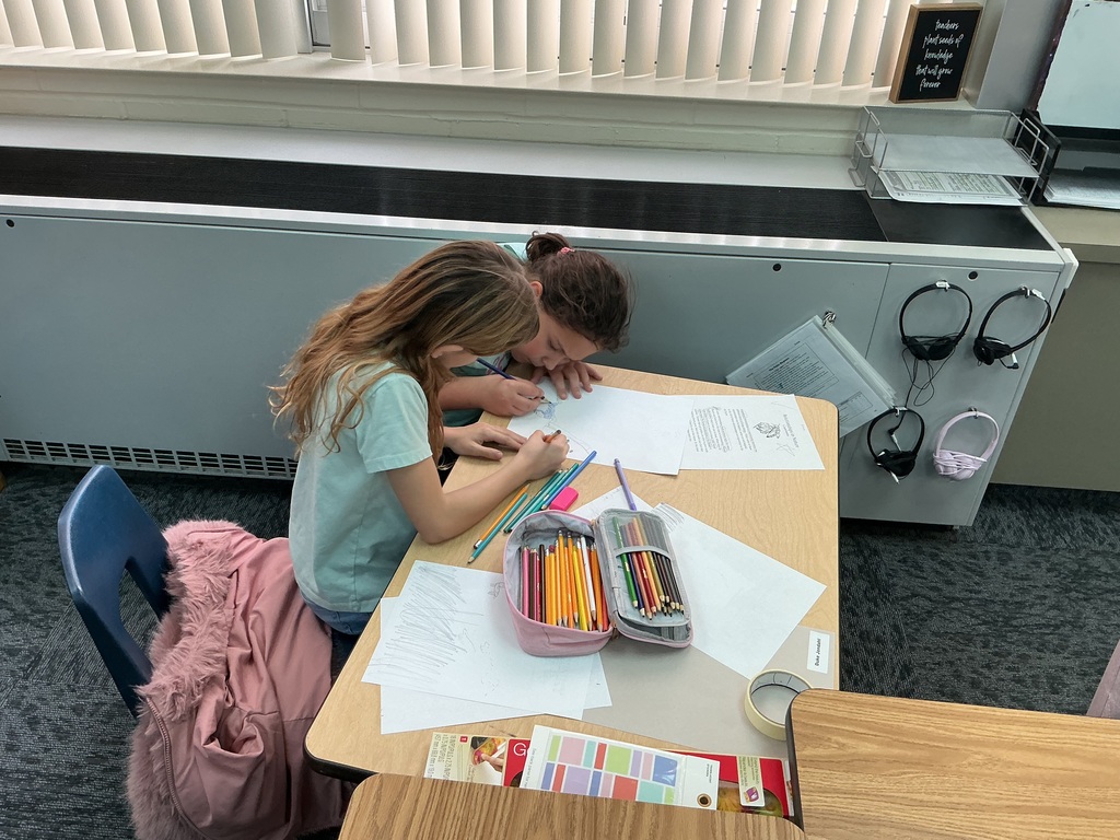 May Overby students making posters to show how plants and animals help each other