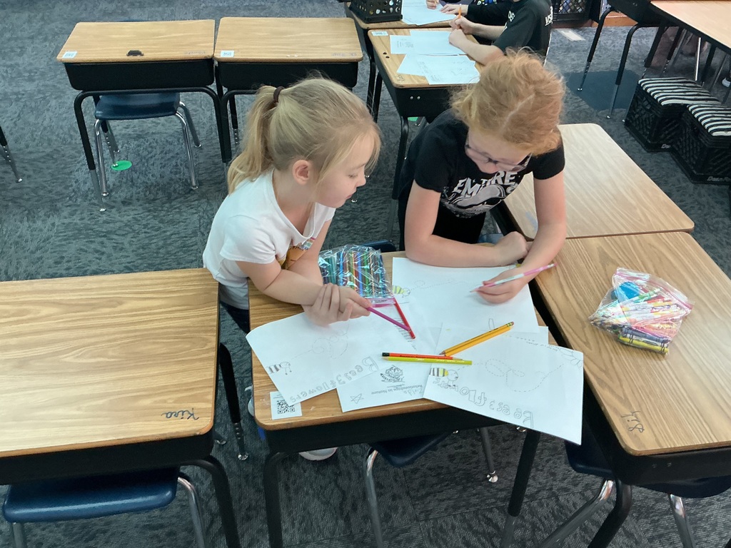 May Overby students making posters to show how plants and animals help each other