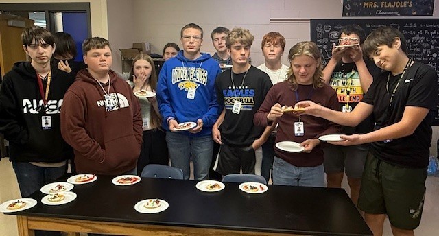 Groups compare their cell designs and discuss how each candy component represents a specific organelle.