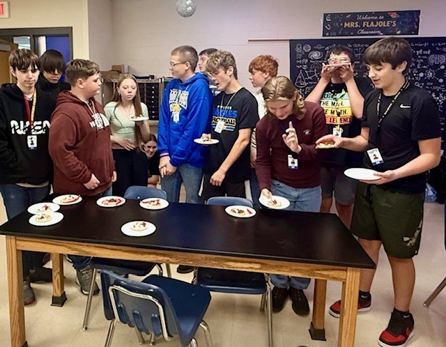 Groups compare their cell designs and discuss how each candy component represents a specific organelle.