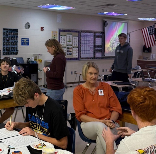 Active discussions fill the classroom as students refine their models and check their work.