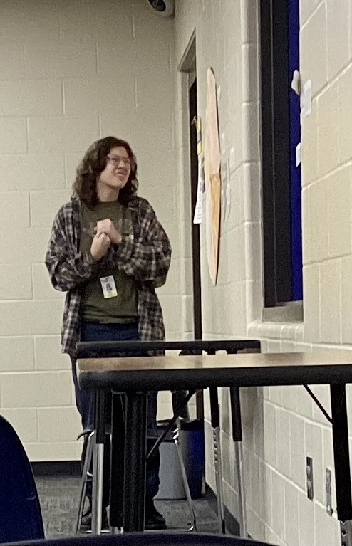 A student shares her project, describing how scale affects planetary placement and spacing.