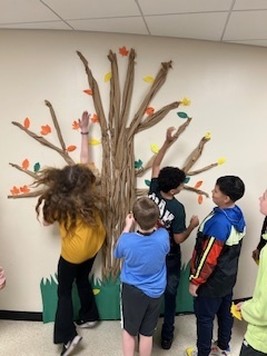 Students adding thankful leaves to our Thankful Tree. 